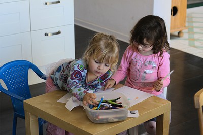 3 year old girls colouring in the kitchen