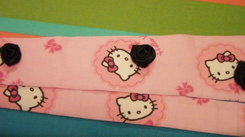 Hello Kitty necktie decorated with black satin roses.